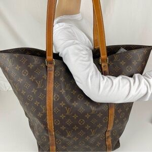 BROKEN STRAP Louis Vuitton: Shopping Tote Carryall
23”W (top) x 14.5”H x 7”D.